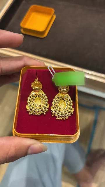 A phone photo of the reverse of the earrings, price tag still attached.